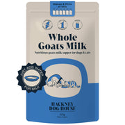 Goat’s milk powder for pets with a measuring scoop beside a bowl of water, ready to mix into a nutritious drink or meal topper.