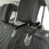 Car seat cover with a quilted pattern and brand logo on a car seat.